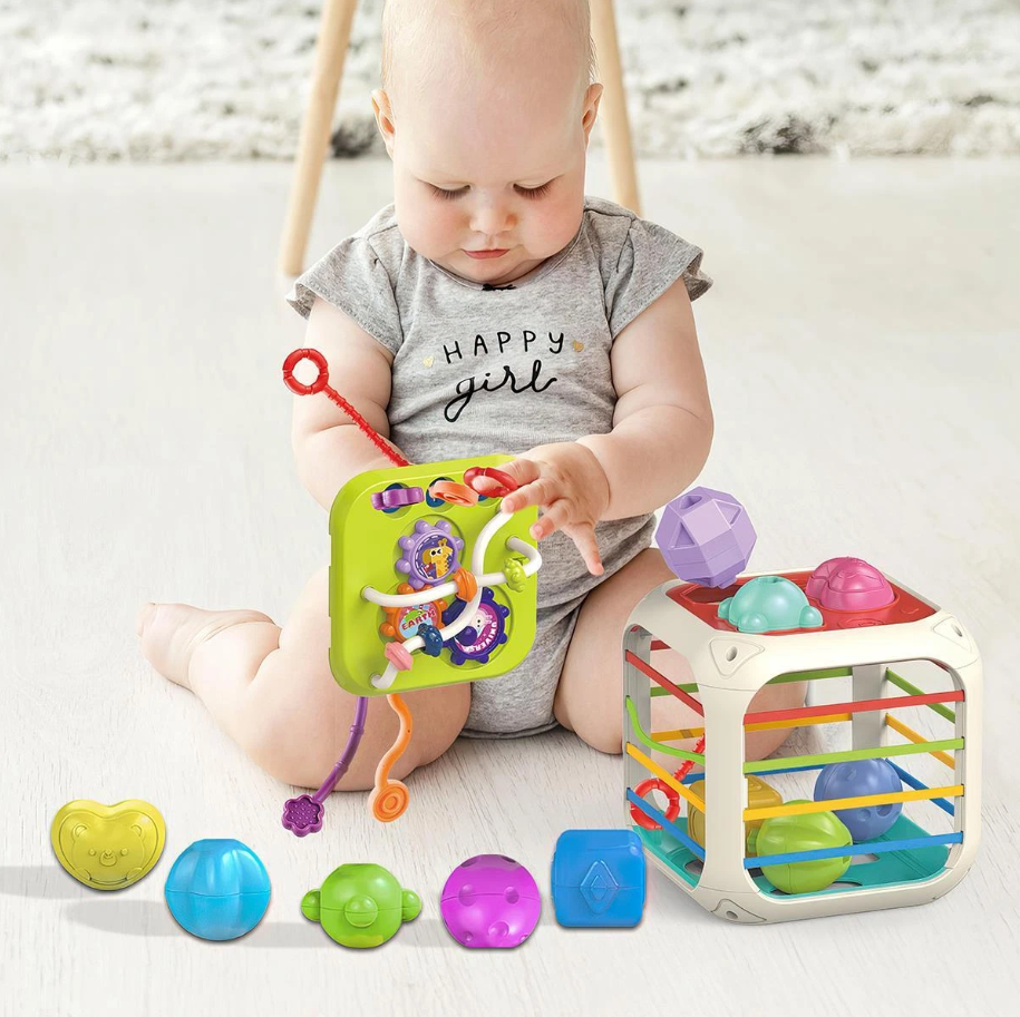 Baby playing with colorful toys on a light-colored floor