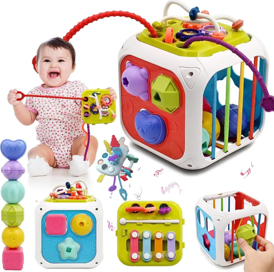 Colorful baby toys including a cube with various interactive elements and a baby sitting next to them.