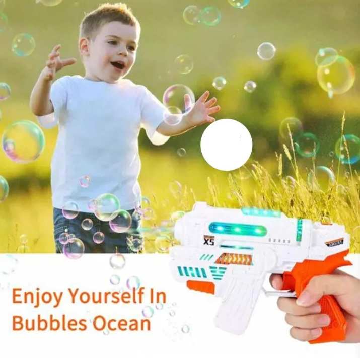 Child playing with a bubble gun in a field with bubbles