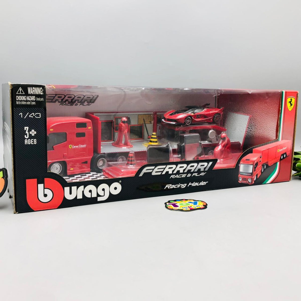 Ferrari toy set packaging with a red racing truck and car on a white background