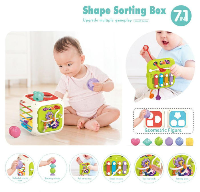 Colorful shape sorting box toy with a baby playing with it on a white background
