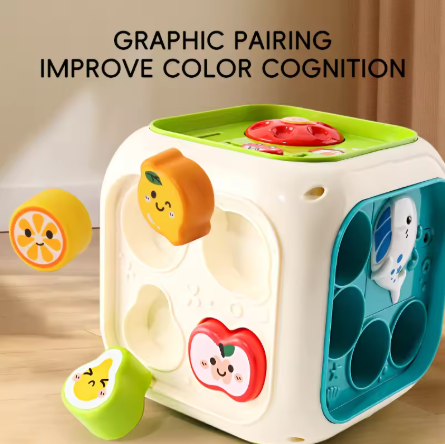 Colorful educational cube with cartoon fruits and shapes on a wooden surface
