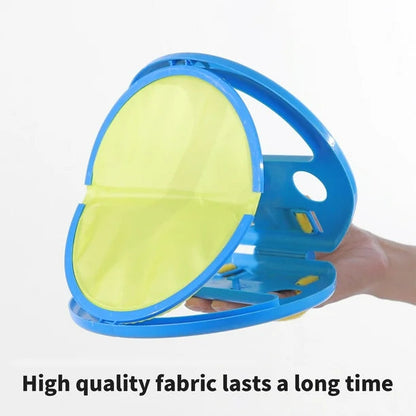 Blue and yellow fabric steamer held by a hand on a white background