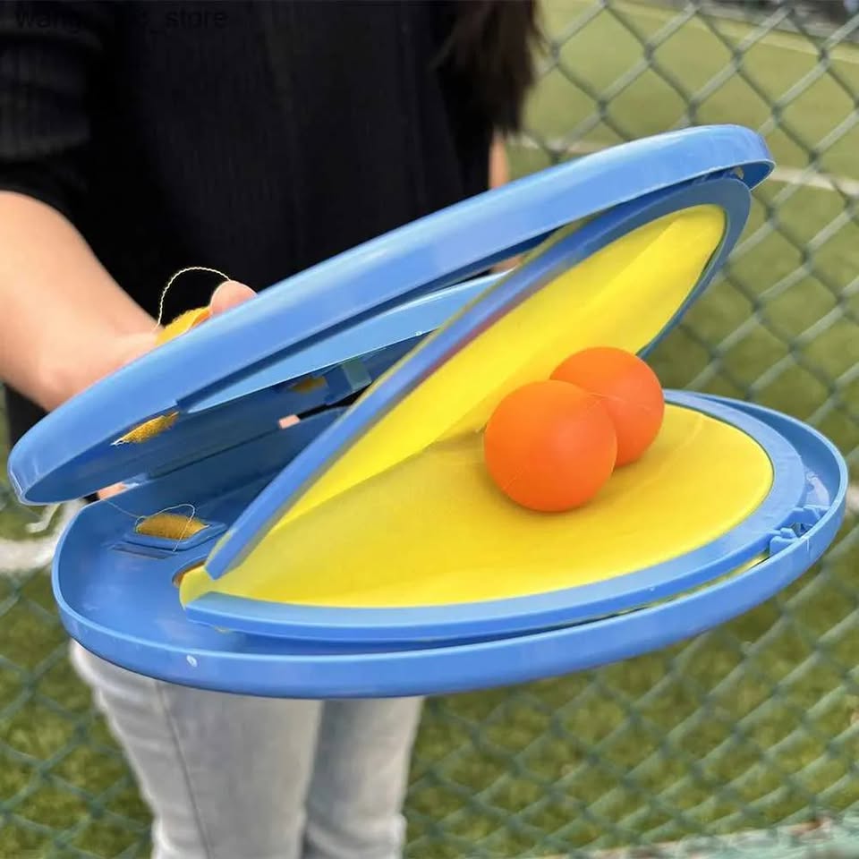Yellow and blue target practice device with orange balls on a grassy background