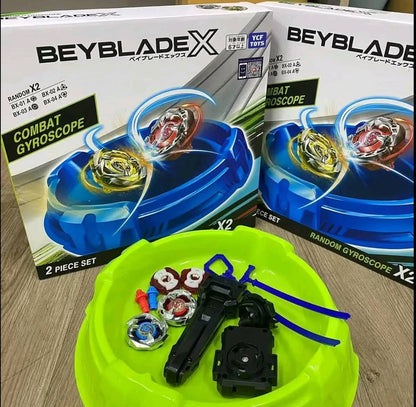 Beyblade X packaging with toys on a green tray