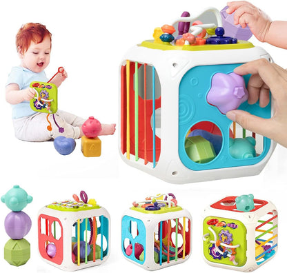 Colorful toy cube with various compartments and a baby playing with it.