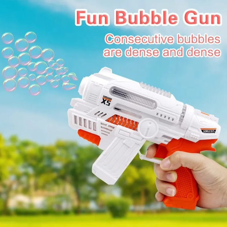 White and orange bubble gun held by a hand with bubbles in the foreground, against a blurred outdoor background.