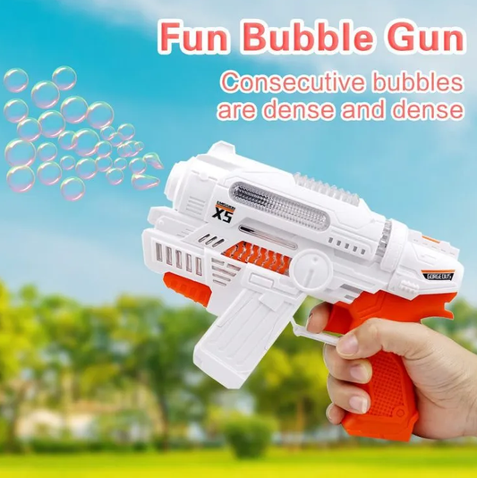 White and orange bubble gun held by a hand with bubbles in the foreground, against a blurred outdoor background.