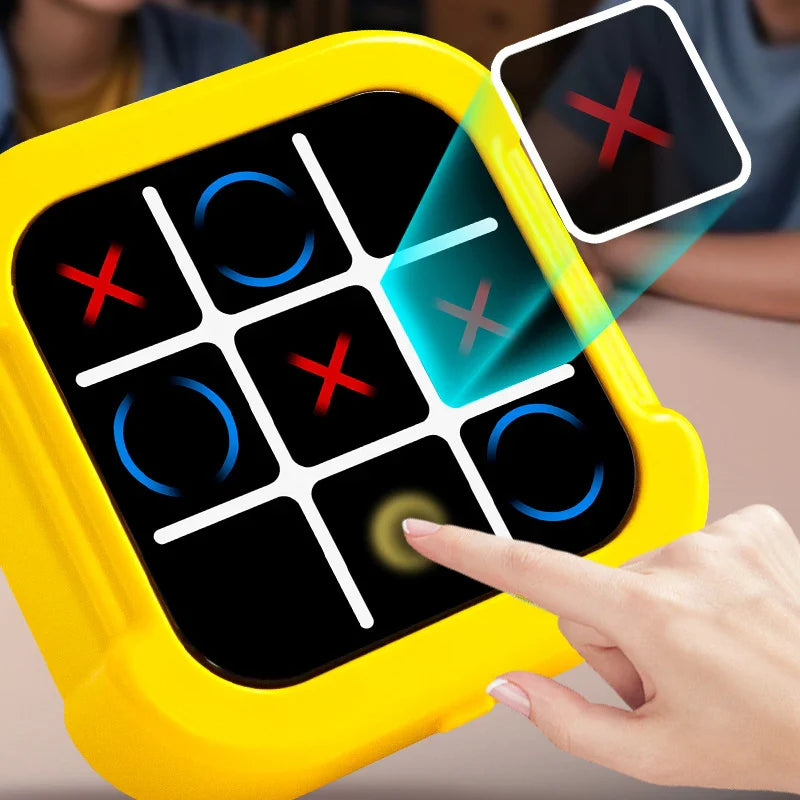 Yellow electronic game device with digital screen displaying tic-tac-toe, being interacted with by a hand.