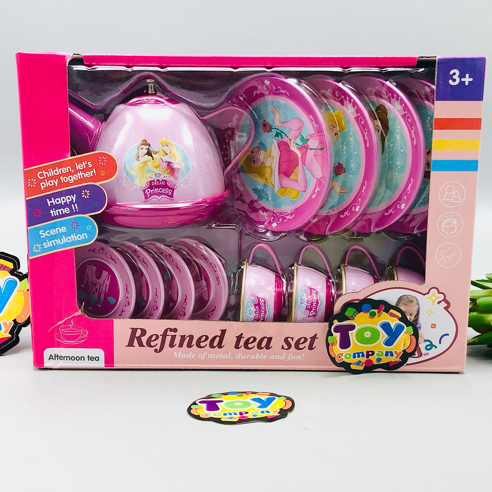 Toy tea set packaging with pink lid and cups, displayed on a white background.