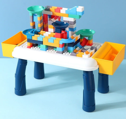 Colorful building block set on a white table with blue legs against a light blue background